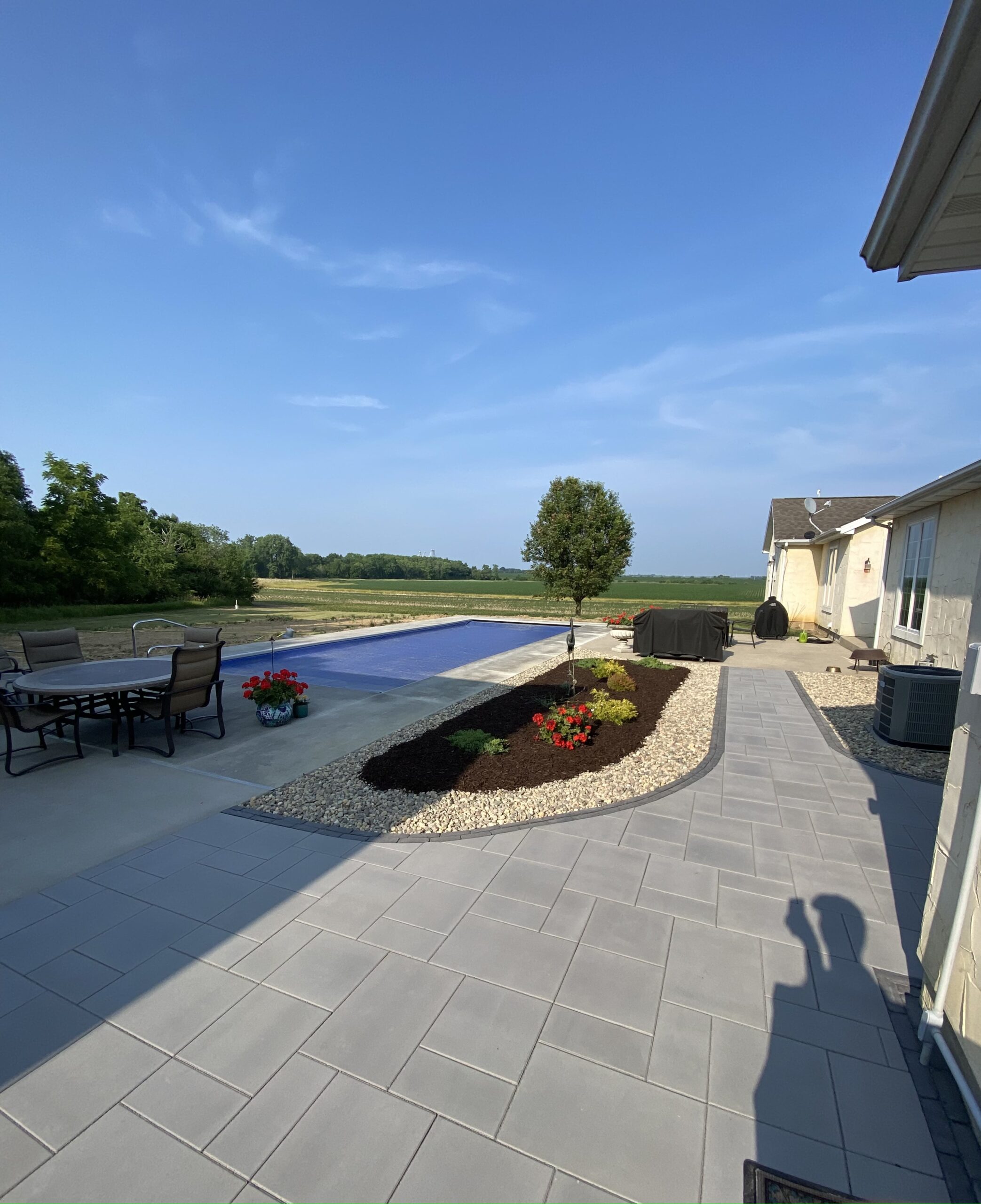 Krueger Lawn and Landscape's paver patio arrangement enhancing the poolside atmosphere