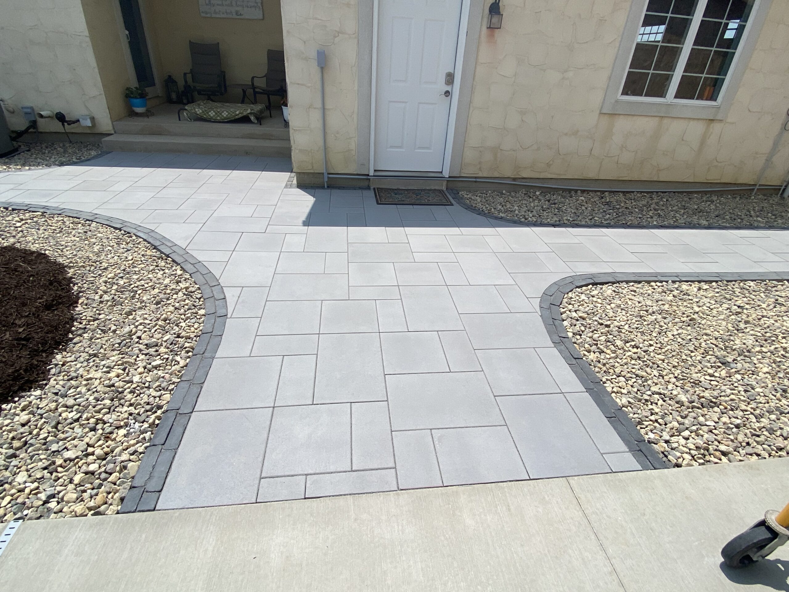 Relax in style on Krueger Lawn and Landscaping's stone edging paver patio.