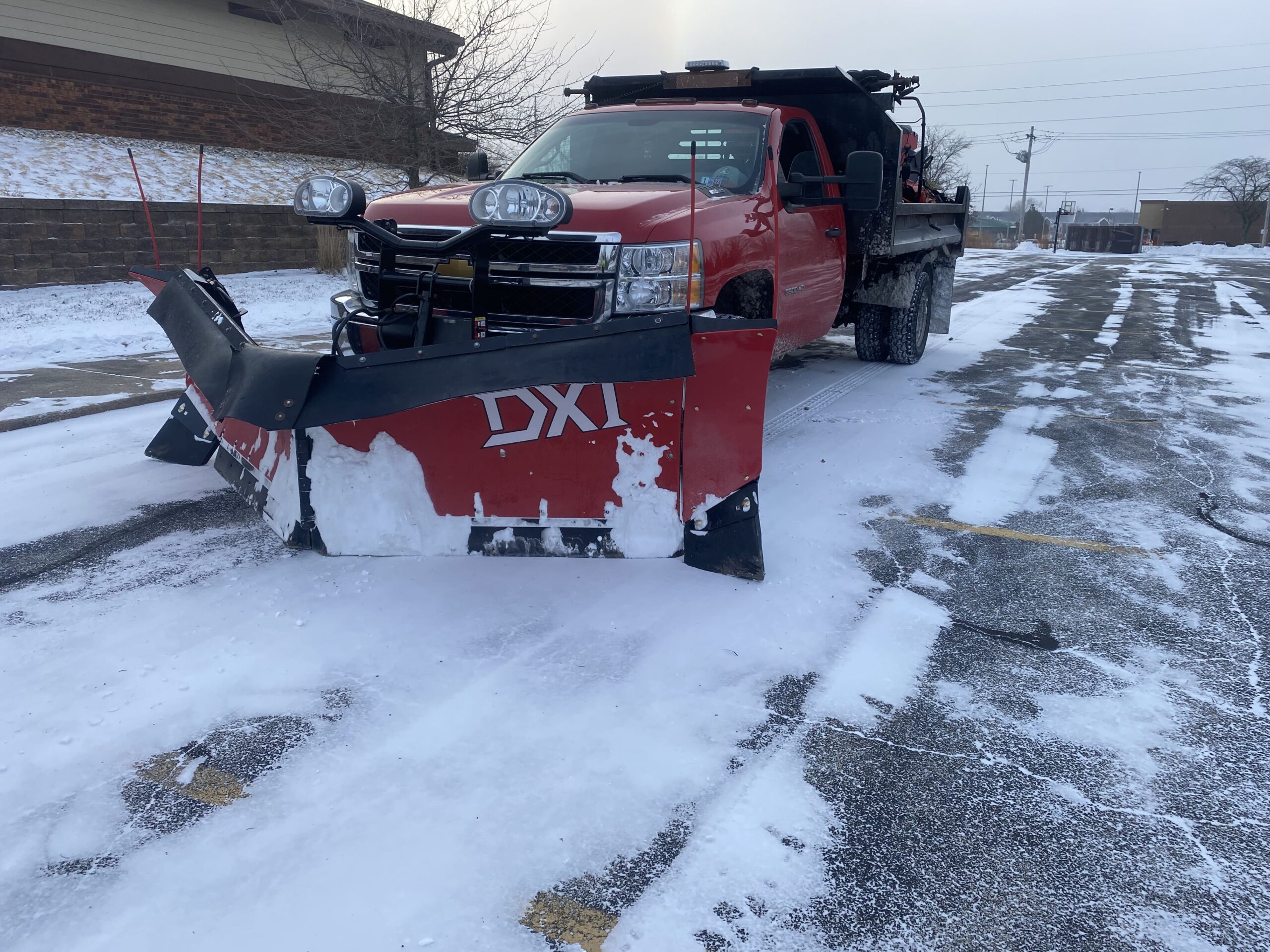 Commercial snow and ice removal by Krueger Lawn and Landscaping.